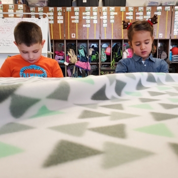 Students making blankets for My Very Own Blanket Organization.